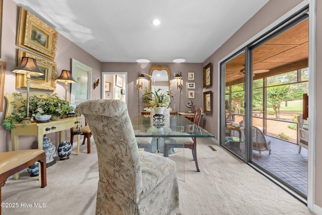 dining space featuring light carpet