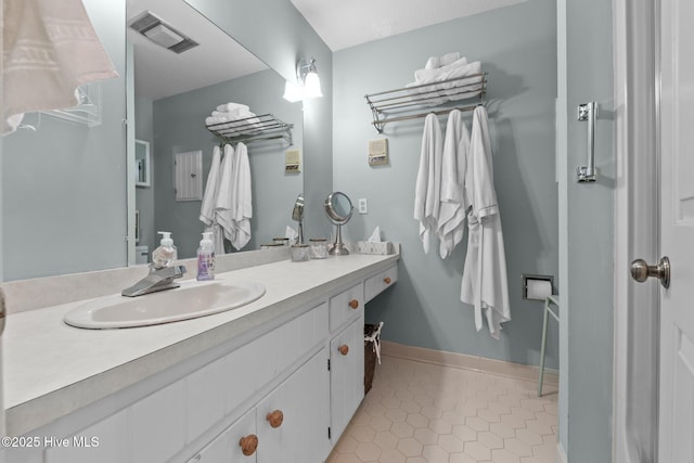 bathroom with tile patterned floors and vanity