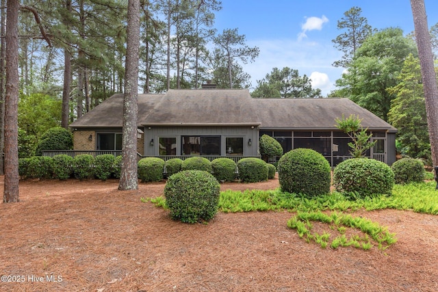 view of front of house featuring roof with shingles and a chimney