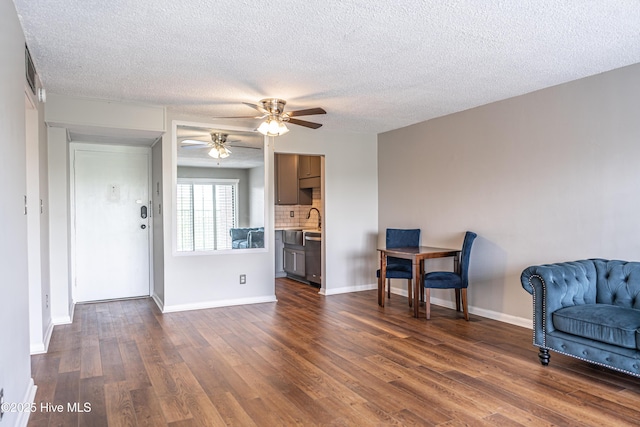 1100 Clarendon St Unit 606, Fayetteville, NC 28305 - living room featuring a ceiling fan, dark wood-type flooring, a textured ceiling, and baseboards