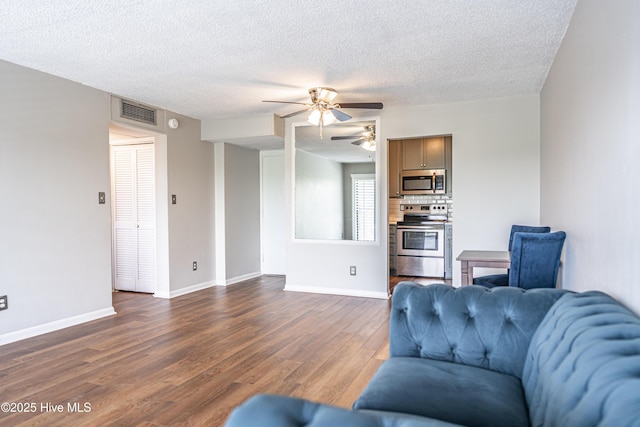 1100 Clarendon St Unit 606, Fayetteville, NC 28305 - living area featuring a ceiling fan, dark wood-type flooring, a textured ceiling, and baseboards