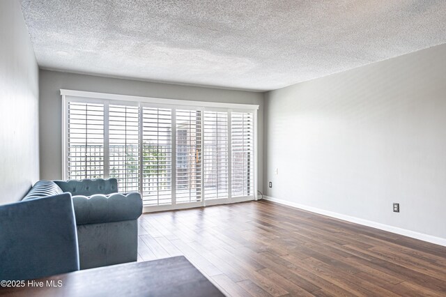 1100 Clarendon St Unit 606, Fayetteville, NC 28305 - living room featuring wood finished floors, a textured ceiling, and baseboards