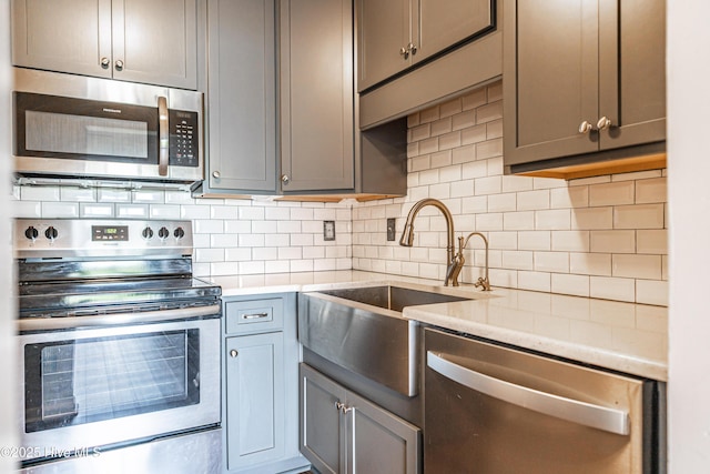 1100 Clarendon St Unit 606, Fayetteville, NC 28305 - kitchen with appliances with stainless steel finishes, decorative backsplash, light countertops, and a sink
