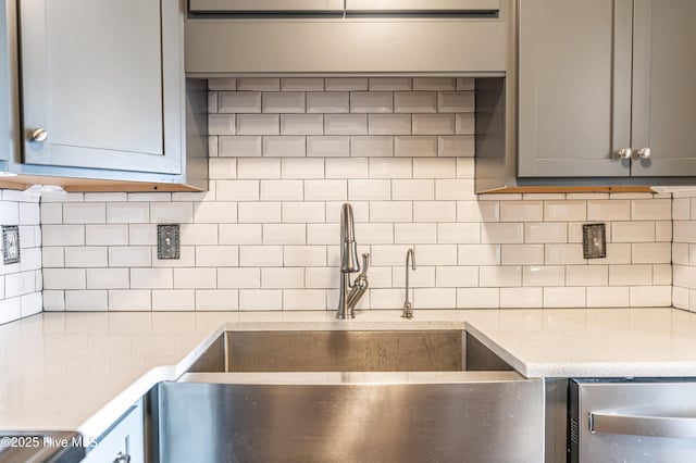 1100 Clarendon St Unit 606, Fayetteville, NC 28305 - kitchen featuring a sink, gray cabinets, tasteful backsplash, dishwashing machine, and light stone counters