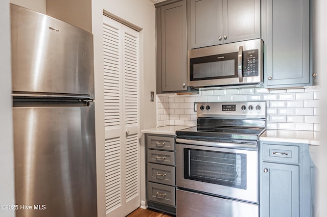 1100 Clarendon St Unit 606, Fayetteville, NC 28305 - kitchen with appliances with stainless steel finishes, light countertops, decorative backsplash, and gray cabinetry