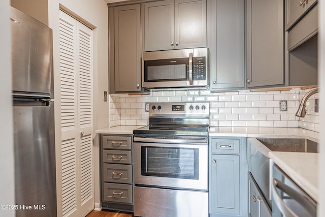 1100 Clarendon St Unit 606, Fayetteville, NC 28305 - kitchen with appliances with stainless steel finishes, decorative backsplash, light countertops, and a sink