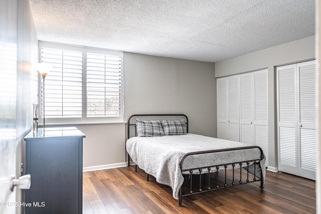 1100 Clarendon St Unit 606, Fayetteville, NC 28305 - bedroom with wood finished floors, a textured ceiling, two closets, and baseboards