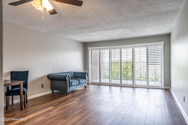 1100 Clarendon St Unit 606, Fayetteville, NC 28305 - sitting room with a ceiling fan, dark wood finished floors, healthy amount of natural light, a textured ceiling, and baseboards