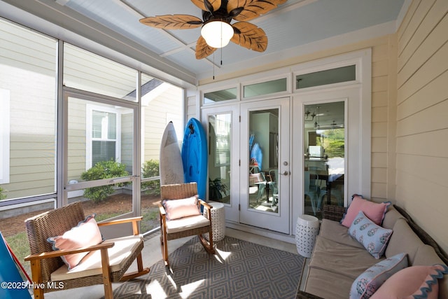 sunroom featuring a ceiling fan and french doors