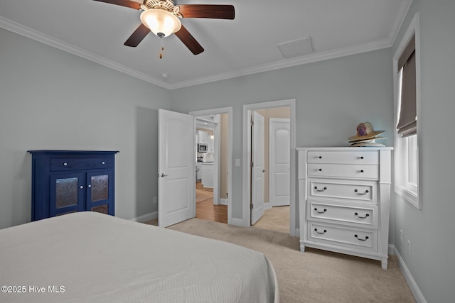 bedroom featuring crown molding, baseboards, light colored carpet, and visible vents
