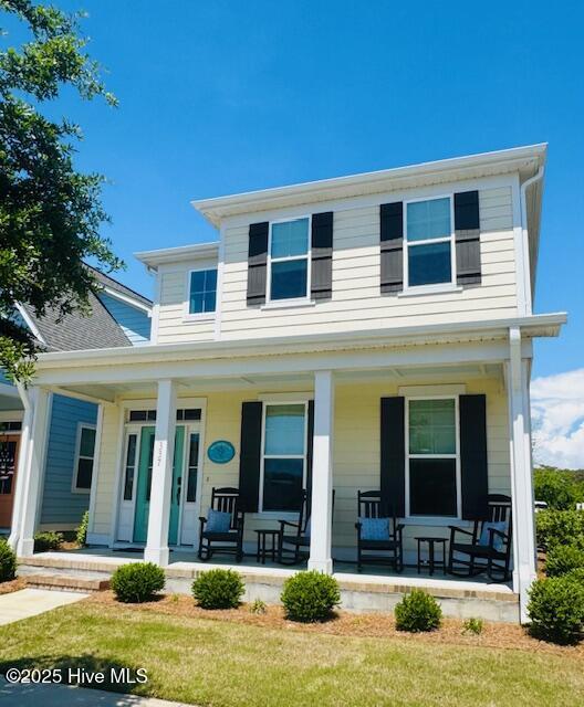 view of front of property with a porch and a front yard