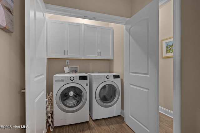 laundry room with independent washer and dryer, baseboards, dark wood-style floors, and cabinet space
