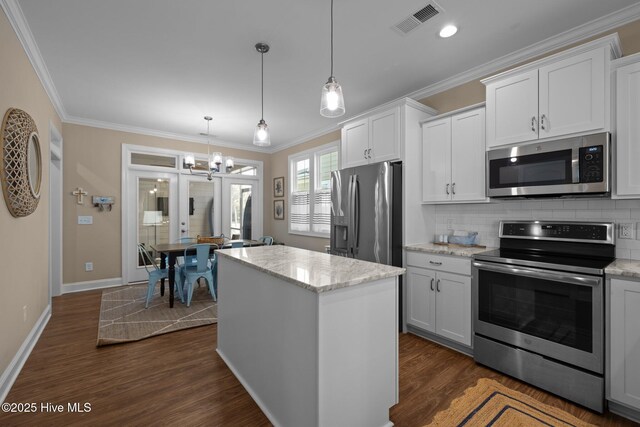 kitchen with visible vents, ornamental molding, decorative backsplash, dark wood finished floors, and appliances with stainless steel finishes
