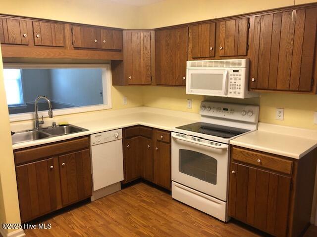 3443 Regency Dr, Wilmington, NC 28412 - kitchen with white appliances, light countertops, and dark wood-style flooring
