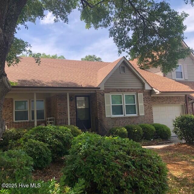 3443 Regency Dr, Wilmington, NC 28412 - ranch-style house with brick siding, a garage, and roof with shingles