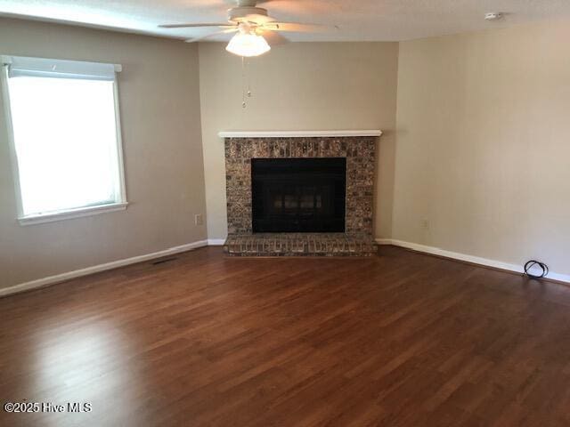 3443 Regency Dr, Wilmington, NC 28412 - unfurnished living room featuring ceiling fan, wood finished floors, and a fireplace with raised hearth