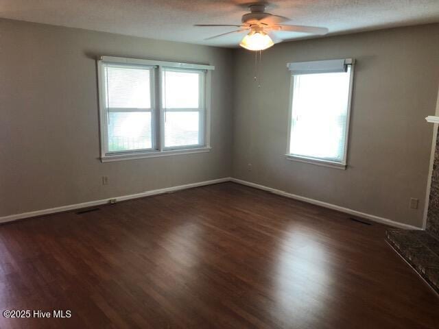 3443 Regency Dr, Wilmington, NC 28412 - spare room featuring healthy amount of natural light, a ceiling fan, and dark wood finished floors