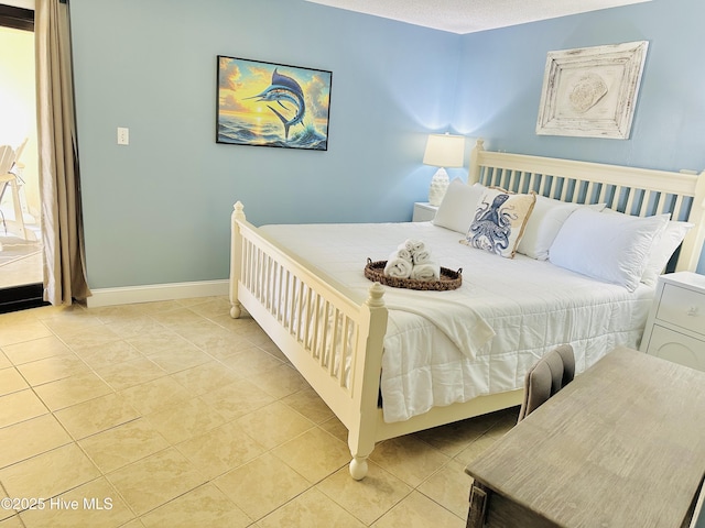 tiled bedroom featuring baseboards