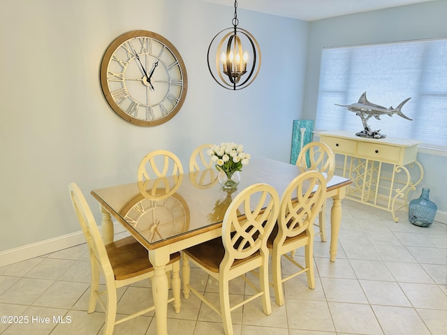 dining space with a chandelier, baseboards, and light tile patterned floors
