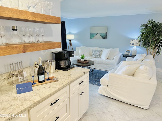 living area featuring light tile patterned floors and a dry bar