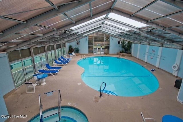 community pool with a patio and an indoor hot tub