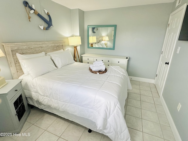 bedroom featuring light tile patterned floors and baseboards