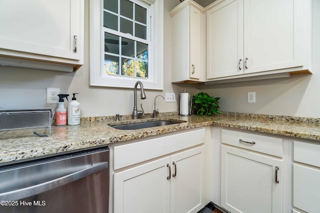 61 Spinnaker Point Rd N, Oriental, NC 28571 - kitchen with stainless steel dishwasher, a sink, white cabinets, and light stone countertops