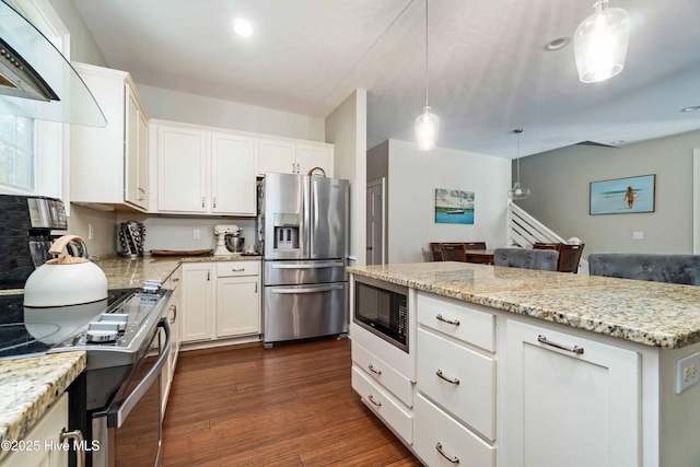 61 Spinnaker Point Rd N, Oriental, NC 28571 - kitchen featuring stainless steel appliances, dark wood-type flooring, light stone countertops, white cabinetry, and decorative light fixtures