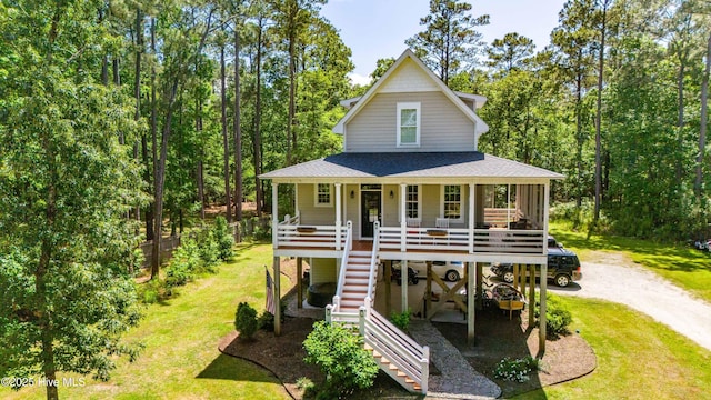 61 Spinnaker Point Rd N, Oriental, NC 28571 - view of front facade with stairs, a shingled roof, covered porch, a front yard, and driveway