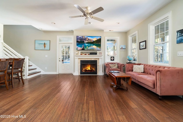 61 Spinnaker Point Rd N, Oriental, NC 28571 - living room featuring stairs, hardwood / wood-style floors, a fireplace, a ceiling fan, and baseboards