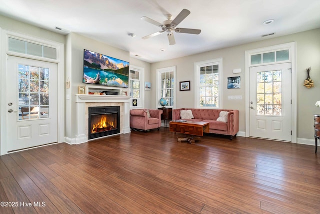 61 Spinnaker Point Rd N, Oriental, NC 28571 - living area featuring a tiled fireplace, wood-type flooring, a ceiling fan, baseboards, and recessed lighting