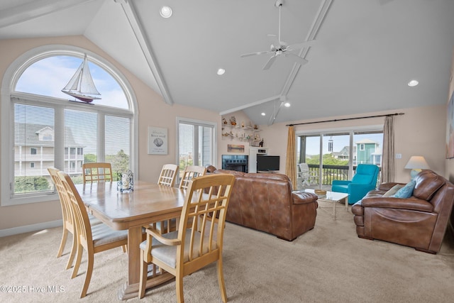 dining space with lofted ceiling, light carpet, recessed lighting, a ceiling fan, and a tiled fireplace
