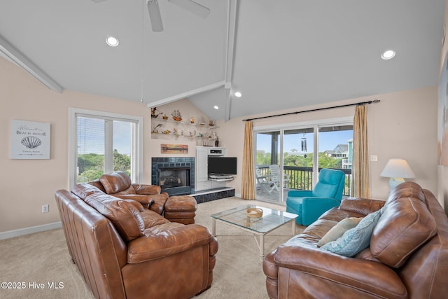 living area featuring plenty of natural light, lofted ceiling, a tiled fireplace, ceiling fan, and recessed lighting