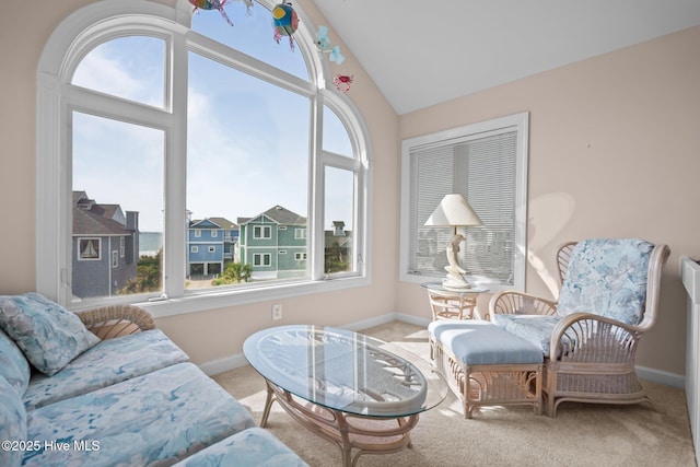 sitting room featuring carpet flooring, baseboards, and lofted ceiling