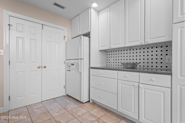 kitchen featuring freestanding refrigerator, white cabinetry, and recessed lighting