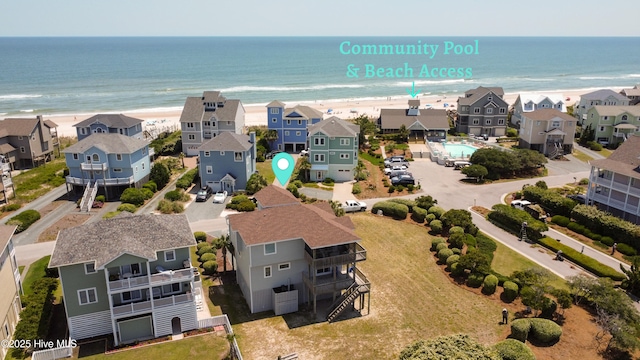 aerial view of residential area featuring waterfront with a beach