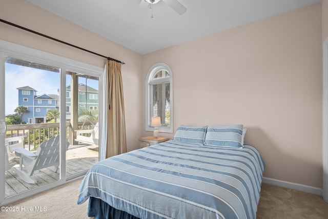 carpeted bedroom with access to exterior, baseboards, and a ceiling fan