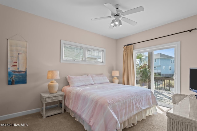 carpeted bedroom featuring access to exterior, baseboards, and a ceiling fan