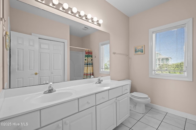 bathroom with healthy amount of natural light, tile patterned floors, toilet, and curtained shower