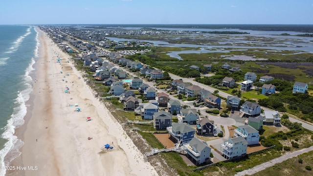 aerial perspective of suburban area featuring waterfront with a beach