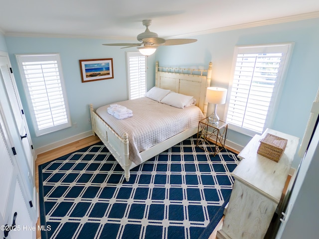 bedroom featuring baseboards, ornamental molding, and ceiling fan