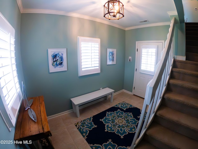 tiled entryway featuring stairway, ornamental molding, a chandelier, and baseboards