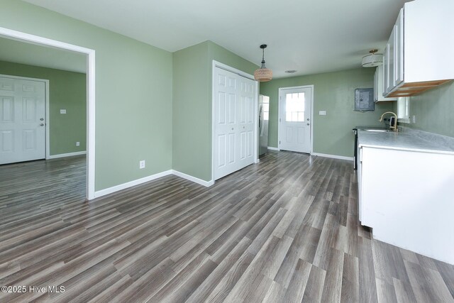 190 NC Highway 32, Sunbury, NC 27979 - kitchen with white cabinets, baseboards, light countertops, and dark wood-style flooring