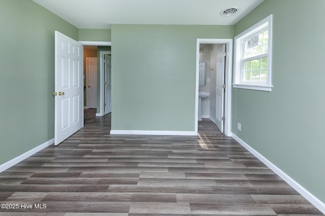 190 NC Highway 32, Sunbury, NC 27979 - unfurnished bedroom featuring dark wood-style flooring, baseboards, and ensuite bath