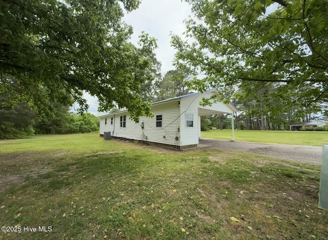 190 NC Highway 32, Sunbury, NC 27979 - view of side of home with a yard, asphalt driveway, and an attached carport