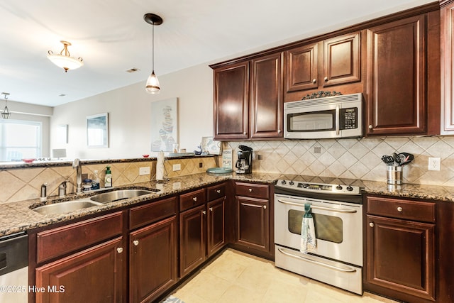 120 SE 58th St Unit 2104, Oak Island, NC 28465 - kitchen with stone countertops, a sink, decorative backsplash, and appliances with stainless steel finishes
