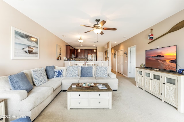 120 SE 58th St Unit 2104, Oak Island, NC 28465 - living area with a ceiling fan and light colored carpet