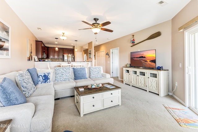 120 SE 58th St Unit 2104, Oak Island, NC 28465 - living area featuring baseboards, light carpet, a ceiling fan, and visible vents