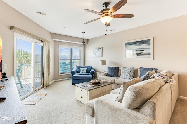 120 SE 58th St Unit 2104, Oak Island, NC 28465 - living room with baseboards, ceiling fan, light carpet, and visible vents