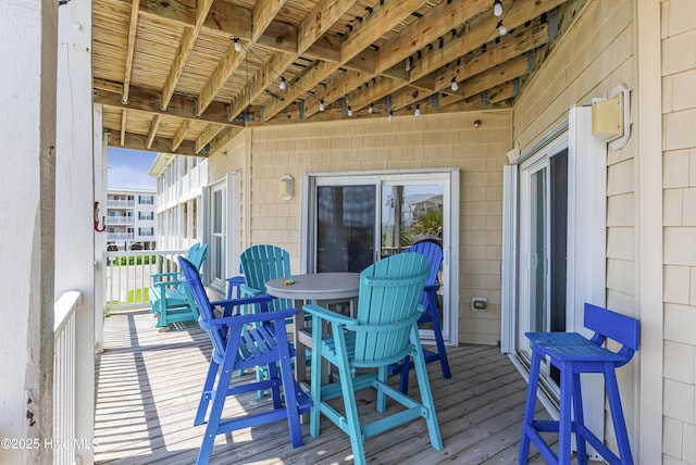 120 SE 58th St Unit 2104, Oak Island, NC 28465 - wooden terrace with outdoor dining space